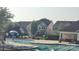 This community pool area offers a fun splash zone for children and relaxation spots with neighborhood homes in the background at 1818 Windy Willow Ln, Dallas, NC 28034