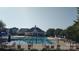 Community pool featuring a spacious swimming area, lounge chairs, and covered seating, perfect for relaxation and recreation at 1818 Windy Willow Ln, Dallas, NC 28034