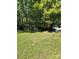 Spacious backyard with mature trees, storage container, and small structure at 194 Wild Plum Ln, Blacksburg, SC 29702