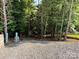 Wooded RV campsite with gravel pad and utility hookups for a serene retreat at 207 Cardinal Dr, New London, NC 28127