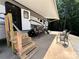 RV with an awning, outdoor chairs and steps at 207 Cardinal Dr, New London, NC 28127