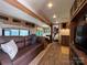 Inviting RV living room with a comfortable sofa, dining area, and a view into the kitchen at 207 Cardinal Dr, New London, NC 28127