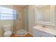 Updated bathroom featuring a glass enclosed shower and modern vanity at 208 S Thompson St, Monroe, NC 28112