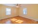 Sunny bedroom featuring hardwood floors and two bright windows at 208 S Thompson St, Monroe, NC 28112