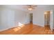 Spacious bedroom with hardwood floors and a view into an en-suite bathroom at 208 S Thompson St, Monroe, NC 28112