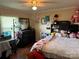A bedroom with a window, a bed, a ceiling fan, and personal decor items at 212 E Texas Ave, Bessemer City, NC 28016