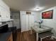 Kitchen with wood-look flooring, white cabinets, and a small eating area with bench seating at 212 E Texas Ave, Bessemer City, NC 28016