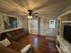 Comfortable living room features hardwood floors, brown sectional sofa, and lots of natural light at 212 E Texas Ave, Bessemer City, NC 28016