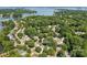 Aerial view of a beautiful lake community with lush trees and a home at 21218 Baltic Dr, Cornelius, NC 28031