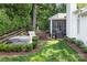 Well-maintained backyard featuring a screened porch, hot tub, and mature landscaping at 21218 Baltic Dr, Cornelius, NC 28031
