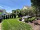 Landscaped backyard with a hot tub, green grass, and privacy fence at 21218 Baltic Dr, Cornelius, NC 28031