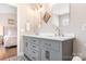 Bathroom features a dual sink vanity with gray cabinets and patterned tile floors at 21218 Baltic Dr, Cornelius, NC 28031