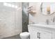Modern bathroom with glass-enclosed shower, white vanity, and neutral color scheme at 21218 Baltic Dr, Cornelius, NC 28031