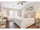 Bright bedroom with vaulted ceiling, wood floors, plush bedding and a cozy desk area at 21218 Baltic Dr, Cornelius, NC 28031