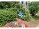 A blue and white community sign with a flower bed sits near a well-kept lawn at 21218 Baltic Dr, Cornelius, NC 28031
