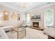 Cozy living room with fireplace, large windows, and comfortable seating arrangements at 21218 Baltic Dr, Cornelius, NC 28031