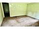 Dilapidated bedroom features torn carpet and damaged walls in a state of disrepair at 2201 Airdale Rd, Lancaster, SC 29720