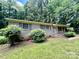 Classic brick home with shutters, a small porch, and landscaping in a green yard at 2201 Airdale Rd, Lancaster, SC 29720