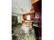 Image of a kitchen in disrepair, featuring damaged flooring, worn cabinets, and visible ceiling damage at 2201 Airdale Rd, Lancaster, SC 29720