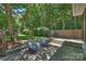 Beautiful backyard patio with a lush bamboo backdrop and comfortable outdoor seating under string lights at 2223 Club Rd, Charlotte, NC 28205