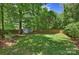 Large, well-maintained backyard with green grass, a storage shed, and a wooden fence for privacy at 2223 Club Rd, Charlotte, NC 28205