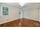 Spacious bedroom with hardwood floors, ample natural light, and large closet at 2223 Club Rd, Charlotte, NC 28205
