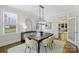Elegant dining room with stylish chandelier, hardwood floors, and ample natural light at 2223 Club Rd, Charlotte, NC 28205