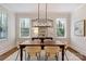 Bright dining room with a modern chandelier and view of the outdoor scenery at 2223 Club Rd, Charlotte, NC 28205