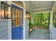 Close-up of a welcoming front porch with stylish lighting and comfortable seating at 2223 Club Rd, Charlotte, NC 28205