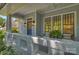 Inviting front porch with stylish seating, decor, and a view of the surrounding landscape at 2223 Club Rd, Charlotte, NC 28205