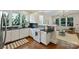 Open kitchen with white cabinets, black countertops, and stainless steel appliances overlooks the living area at 2223 Club Rd, Charlotte, NC 28205