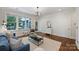 Bright living room featuring hardwood floors, large windows, and a view of the backyard at 2223 Club Rd, Charlotte, NC 28205
