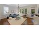 Inviting living room with large windows, hardwood floors, and a comfortable seating arrangement at 2223 Club Rd, Charlotte, NC 28205
