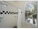 Bright shower featuring white tile with black accents and a window at 2223 Club Rd, Charlotte, NC 28205