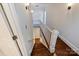 Elegant staircase with hardwood steps and white railings at 2223 Club Rd, Charlotte, NC 28205