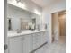 Bathroom with double sink vanity, tile flooring, and a door to a shower room and walk-in closet at 2261 Lincolnshire Ln, Waxhaw, NC 28173