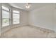 Bright bedroom features large windows with natural light, and neutral carpet at 2261 Lincolnshire Ln, Waxhaw, NC 28173