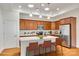 Stylish kitchen featuring stainless steel appliances, central island and wood cabinets at 2261 Lincolnshire Ln, Waxhaw, NC 28173