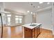 Bright kitchen with island, stainless sink, and a connected dining area with natural light at 2261 Lincolnshire Ln, Waxhaw, NC 28173