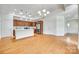 Open concept kitchen with island, stainless steel appliances, and hardwood floors at 2261 Lincolnshire Ln, Waxhaw, NC 28173