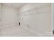 An empty laundry room with tile flooring and wire shelving, ready for customization at 2261 Lincolnshire Ln, Waxhaw, NC 28173