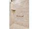 Tiled shower featuring a built-in shelf, shower head, and grab bar at 2261 Lincolnshire Ln, Waxhaw, NC 28173