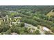 Aerial view of neighborhood near lake featuring wooded lots, community pool, and winding streets at 274 Cove Creek Loop, Mooresville, NC 28117