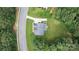 Drone shot of home showing roof, driveway, lawn, landscaping, and tree coverage on home site at 274 Cove Creek Loop, Mooresville, NC 28117