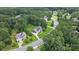 Aerial view of a home nestled among lush green trees in a quiet neighborhood at 274 Cove Creek Loop, Mooresville, NC 28117
