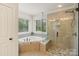 Luxurious bathroom with soaking tub, glass shower, and stylish tile work at 274 Cove Creek Loop, Mooresville, NC 28117