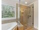 Elegant bathroom featuring a glass shower and views of the outdoors at 274 Cove Creek Loop, Mooresville, NC 28117