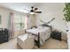 Charming bedroom with patterned bedding, a ceiling fan, and natural lighting at 274 Cove Creek Loop, Mooresville, NC 28117