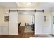 Bonus room area with barn doors leads to exercise room with weights and workout equipment at 274 Cove Creek Loop, Mooresville, NC 28117