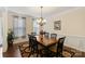 Dining room features wooden table, chandelier, neutral walls, and ample natural light at 274 Cove Creek Loop, Mooresville, NC 28117
